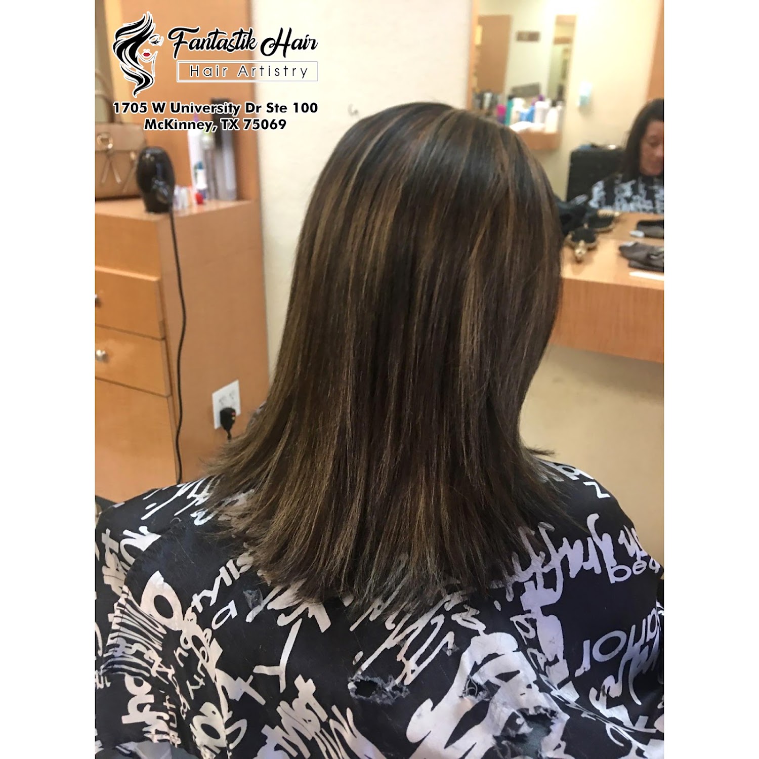 A finished cut with warm highlights, photographed at the salon station.